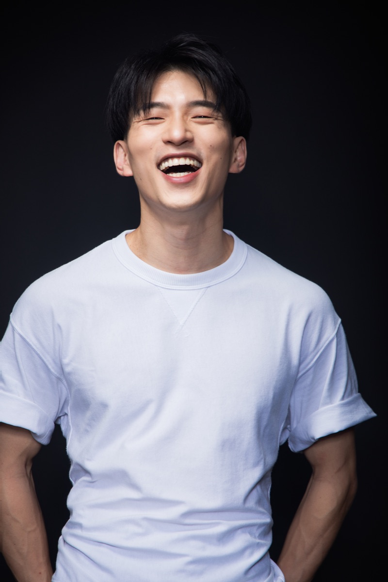 Terrence Leung laughing in a studio portrait