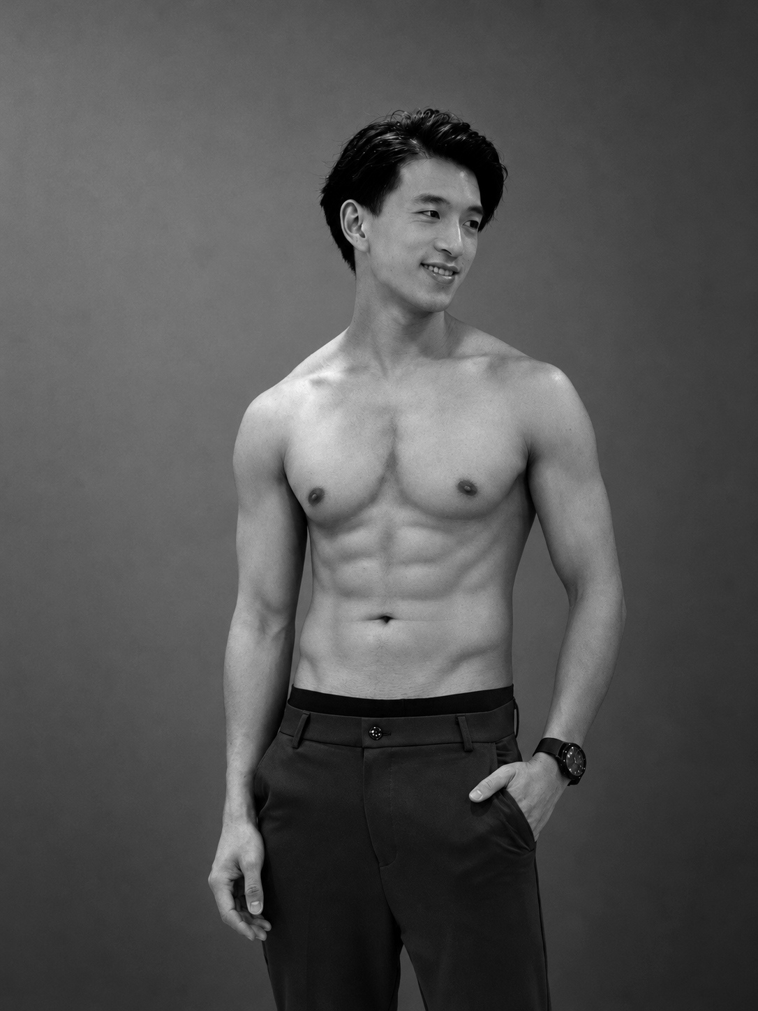 Black-and-white studio portrait of Terrence Leung smiling, framed from the waist up.