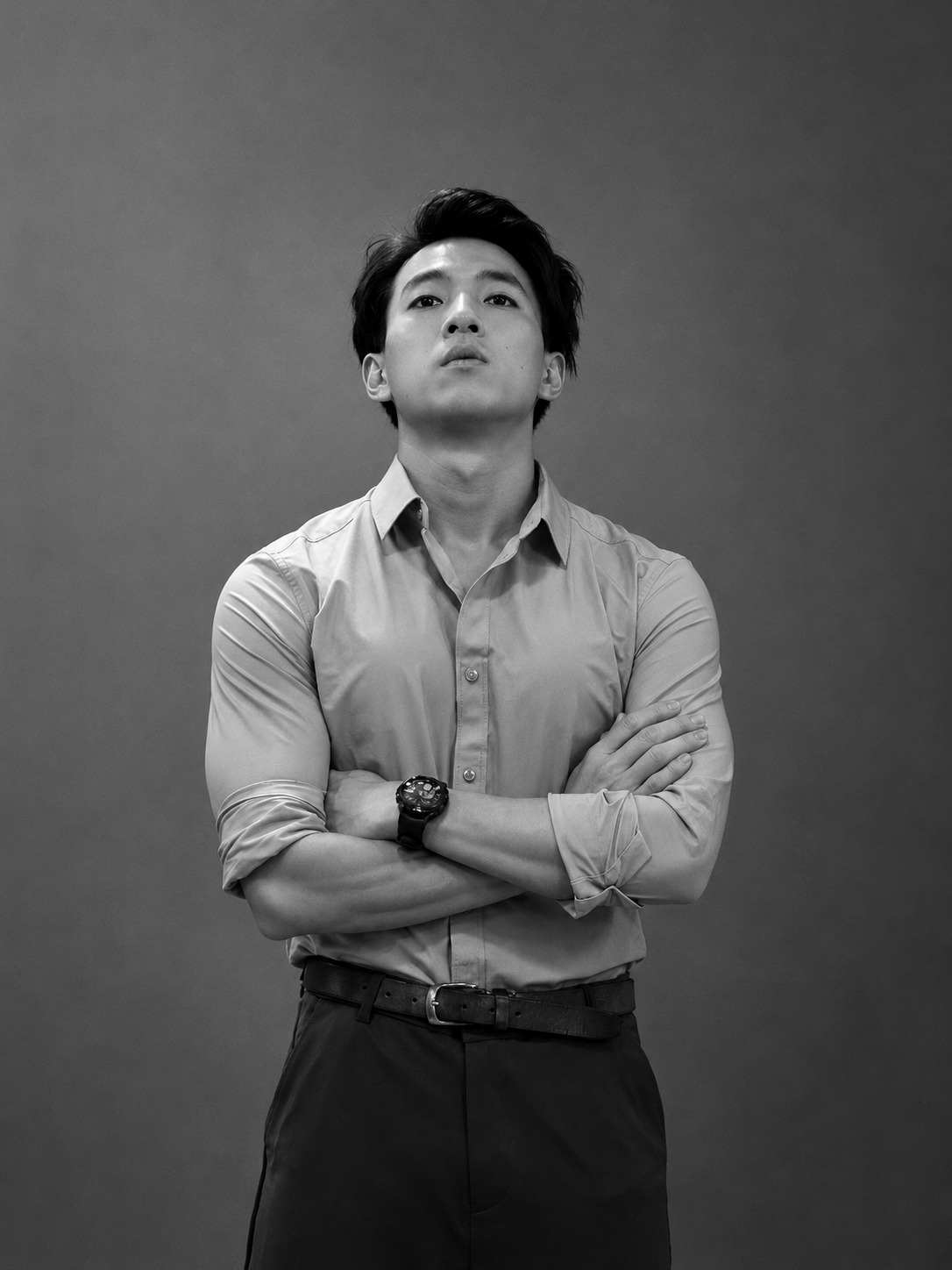 Black-and-white studio portrait of Hong Kong actor Terrence Leung in an open-collar shirt, arms crossed.